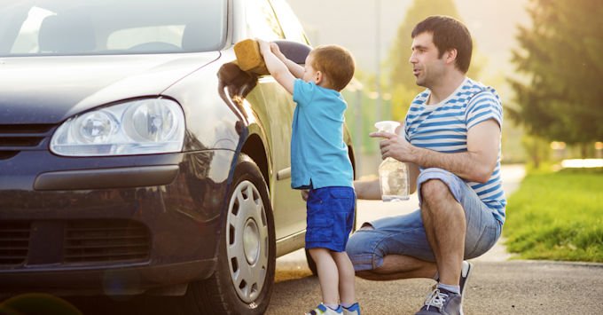 Father and son washing car